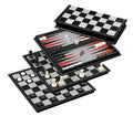Layered black and silver game boards for chess, checkers, and backgammon with black and white pieces and dice.