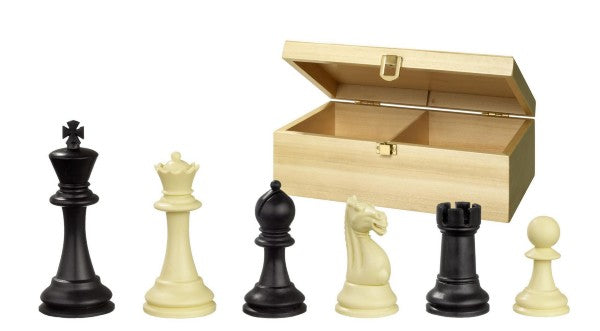 Six black and cream chess pieces stand in front of an open light wood storage box with two compartments.