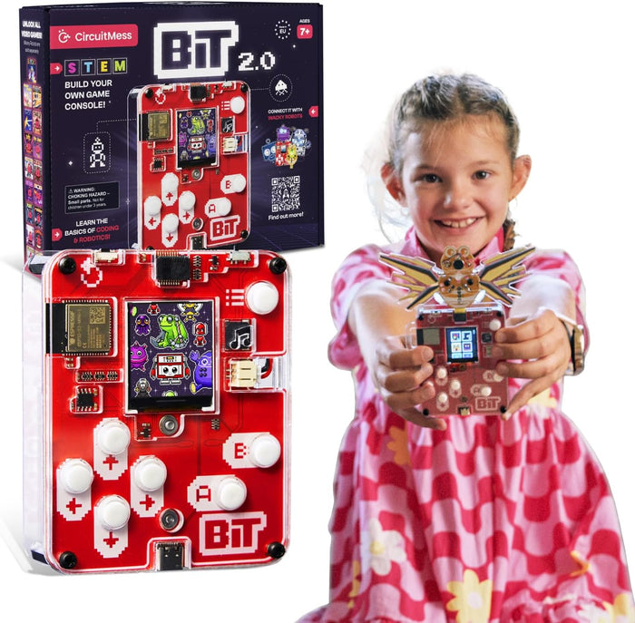 Red DIY handheld gaming console with white buttons and pixel art screen, shown with product box and a young girl.