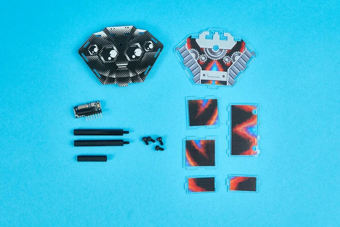 Patterned hexagonal plates, a circuit board, and hardware for a DIY robot kit on a bright blue background.