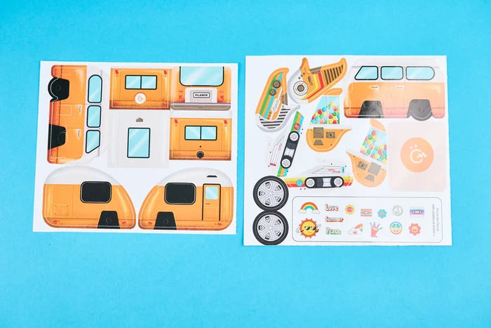 Punch-out sheets for an orange retro camper van with wheels and colorful decorative stickers on a bright blue background.