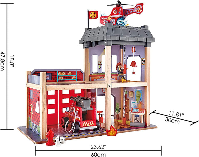 Multi-story wooden toy fire station with red fire engine, helicopter, and firefighter figure, plus labeled dimensions.
