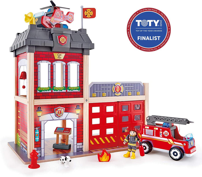 Two-story red brick wooden fire station with a fire truck, helicopter, firefighter, and Dalmatian dog.