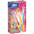 Bright pink Clementoni craft kit box showing three glitter-filled pens with unicorn, star, and rainbow cloud toppers.