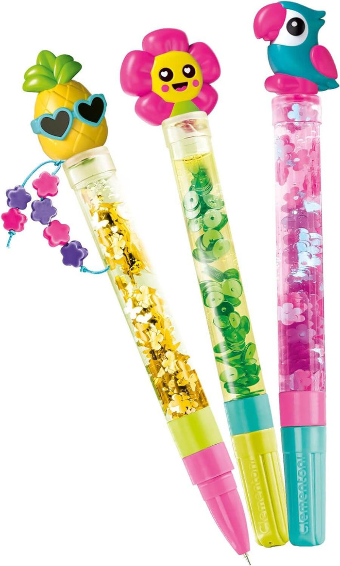 Three tropical pens with pineapple, flower, and parrot toppers, featuring colorful liquid and glitter barrels.