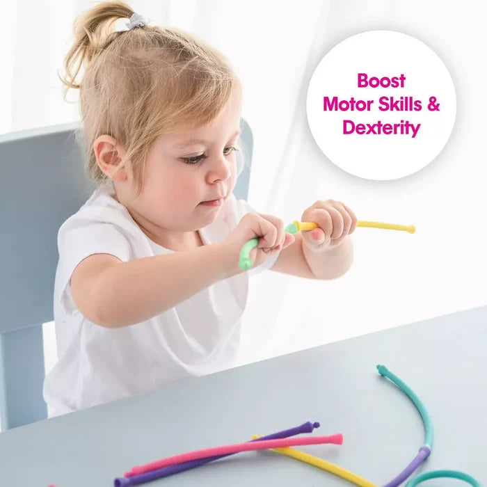 Toddler girl connecting colorful flexible toy threads. Text: Boost Motor Skills & Dexterity.