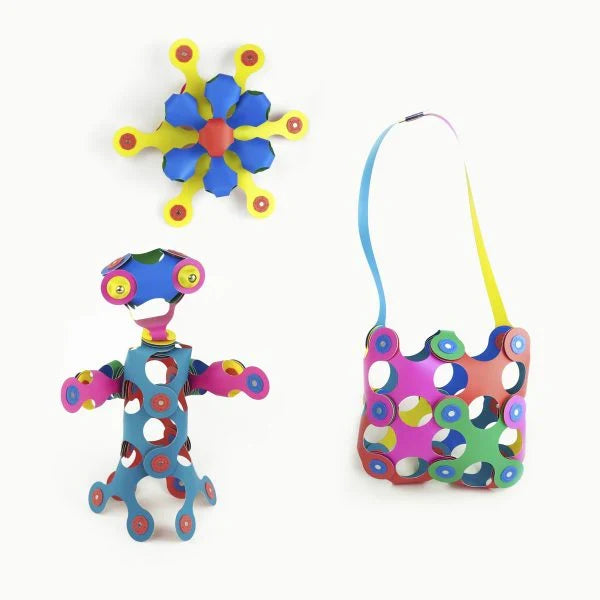 Colorful star, robot, and bag creations made from flexible, multicolored magnetic building pieces.