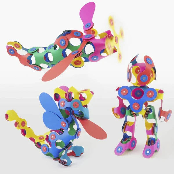 Flexible magnetic strips in rainbow colors built into a toy robot, airplane, and winged dragon on white.