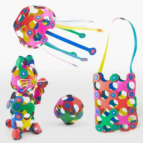 Brightly colored flexible toy pieces built into a 3D cat, jellyfish, ball, and tote bag against a white backdrop.