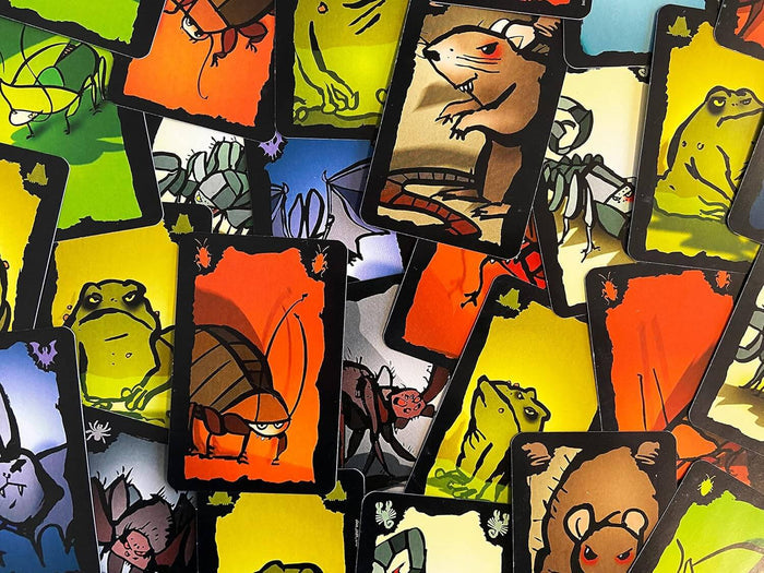 Colorful pile of playing cards featuring cartoonish illustrations of cockroaches, rats, and frogs on bright backgrounds.