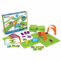 Blue robot mouse toy with green tiles, orange arches, purple walls, yellow cheese, and coding cards next to the box.