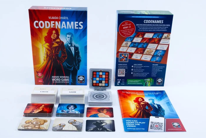 Codenames board game box and components including word cards, agent tiles, and rulebook on a white background.