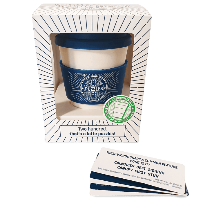 Blue bamboo travel mug in a sunburst patterned gift box with a stack of puzzle cards in front.