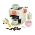 Cream wooden toy espresso machine with colorful floral cups, portafilter, felt coffee beans, and sugar cubes.