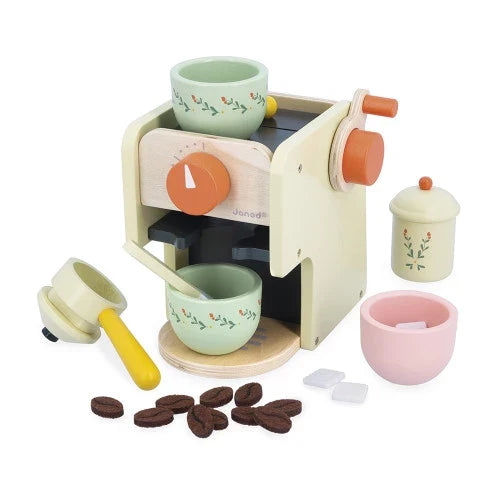 Cream wooden toy espresso machine with colorful floral cups, portafilter, felt coffee beans, and sugar cubes.