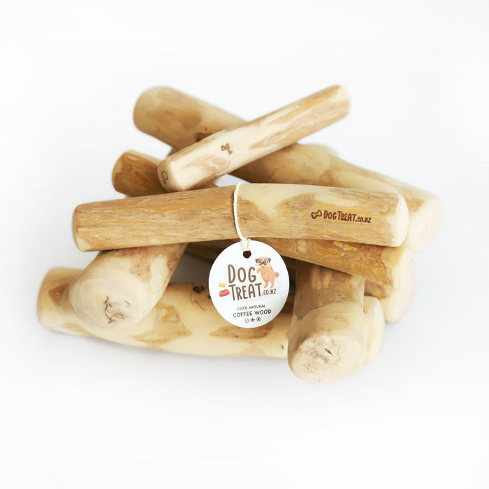 Dog enjoying a Coffee Wood Chew from DogTreatNZ, showcasing a natural wooden chew toy for dogs.