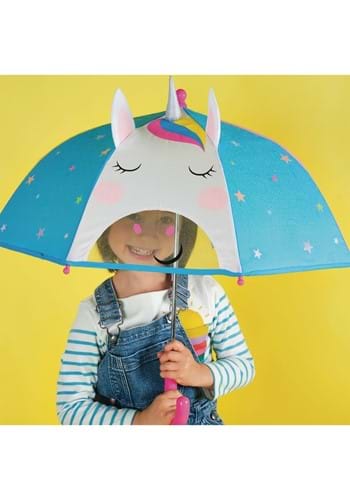 Child holding a blue 3D unicorn umbrella with ears, horn, and a clear viewing window against a yellow background.