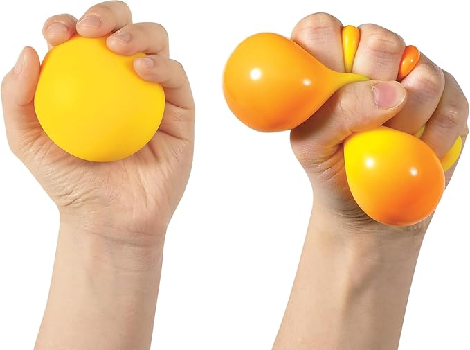 Hands squeezing a yellow squishy ball that turns orange under pressure, demonstrating its color-changing effect.