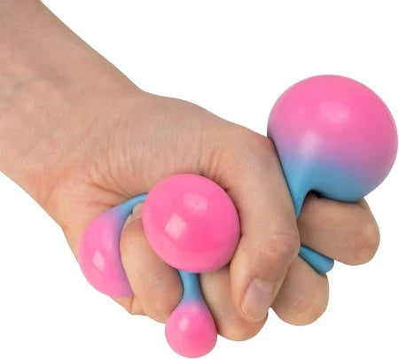 Hand squeezing a soft blue ball that turns pink as it bulges into spheres between the fingers.