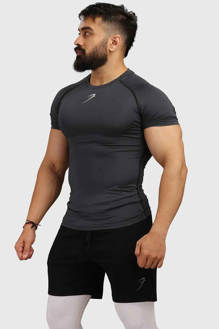 Grey compression T-shirt by Fuaark Nz, close-up showing soft fabric and fitted design for athletic performance.