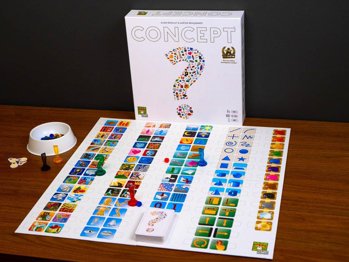 White board game box with icon question mark and matching symbol board with colorful pawns and cards on a wooden table.