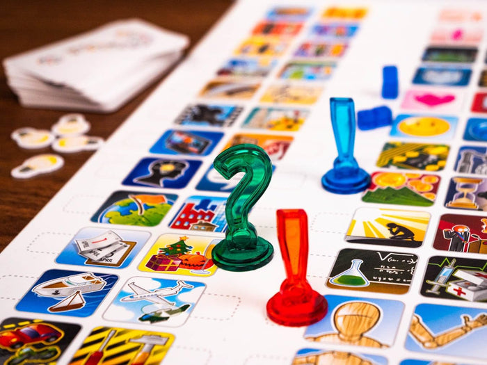 Game board with various icon tiles and translucent green question mark and red exclamation mark pieces.
