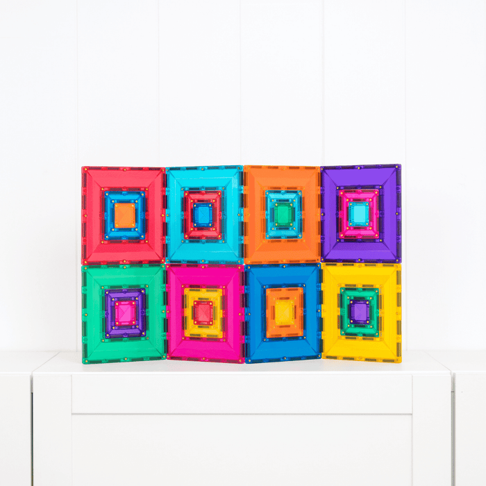 Eight colorful square magnetic tiles with nested portal windows arranged in a 2x4 grid on a white surface.