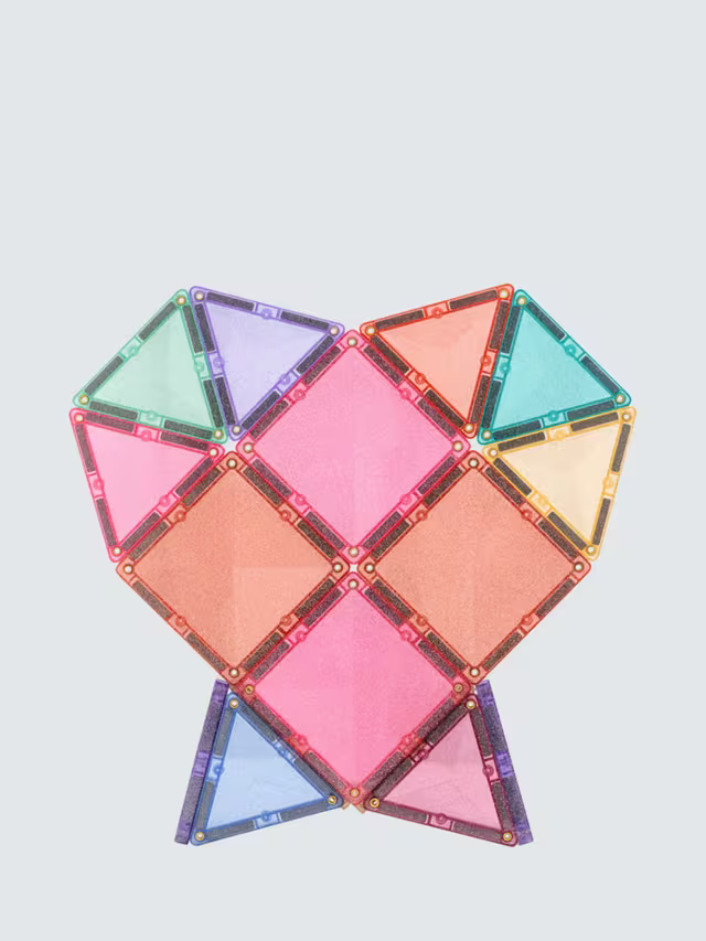 Pastel-colored translucent magnetic squares and triangles with glittery edges arranged in a heart shape.