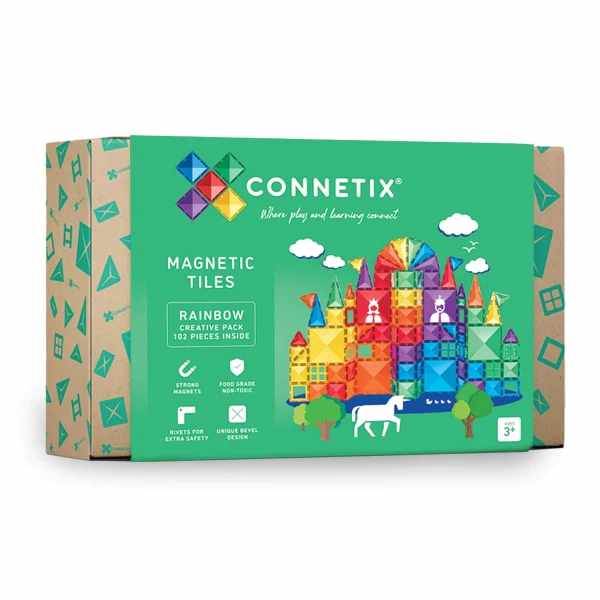 Green box for magnetic tiles featuring a colorful rainbow castle illustration, white unicorn, and trees.