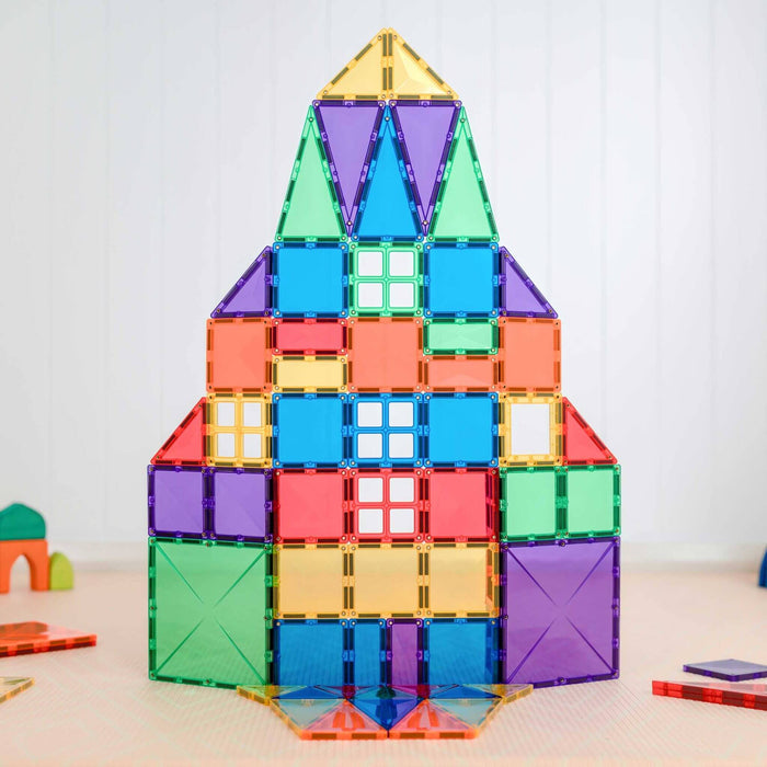 Colorful rocket ship built from translucent magnetic square and triangle tiles in vibrant rainbow colors.