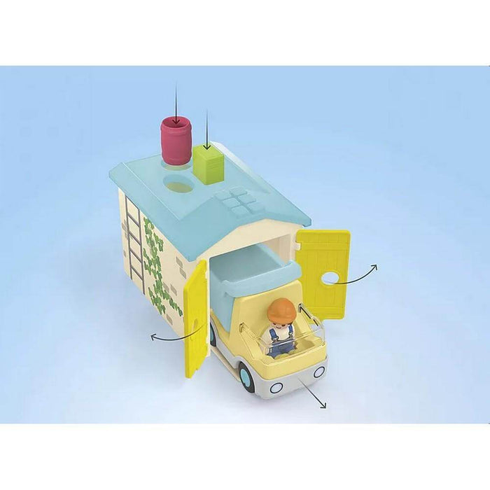 Yellow construction truck with driver exiting a garage. Arrows highlight opening yellow doors and roof pieces.