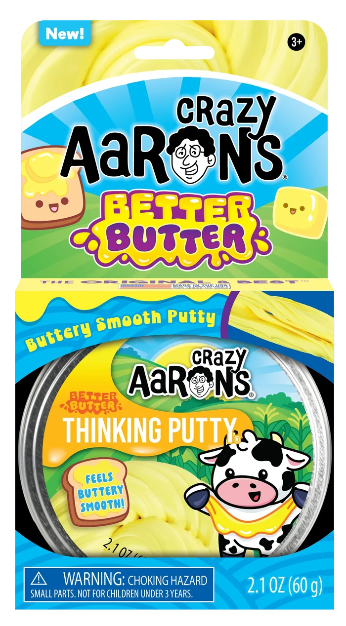 Yellow thinking putty in a tin. Bright blue and yellow packaging features a cartoon cow, toast, and yellow putty swirls.