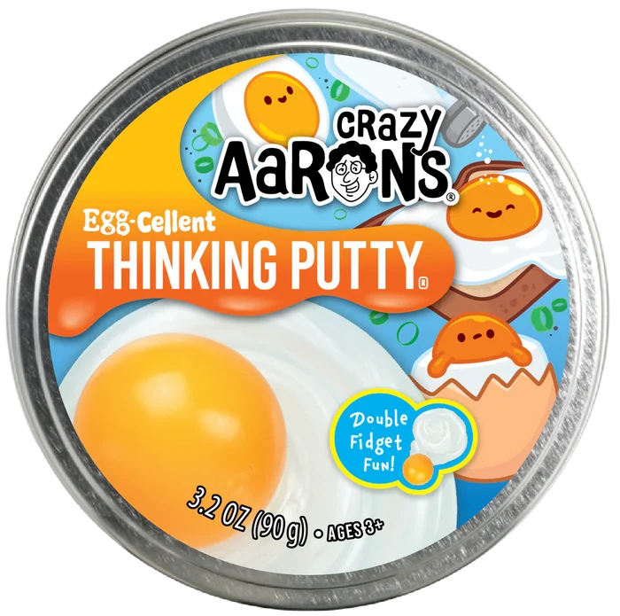 Circular metal tin lid for Egg-cellent Thinking Putty with fried egg graphics and a large yellow yolk.