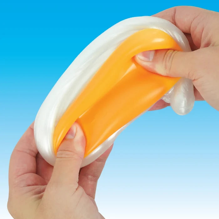 Hands stretching white and orange putty resembling a fried egg against a light blue background.