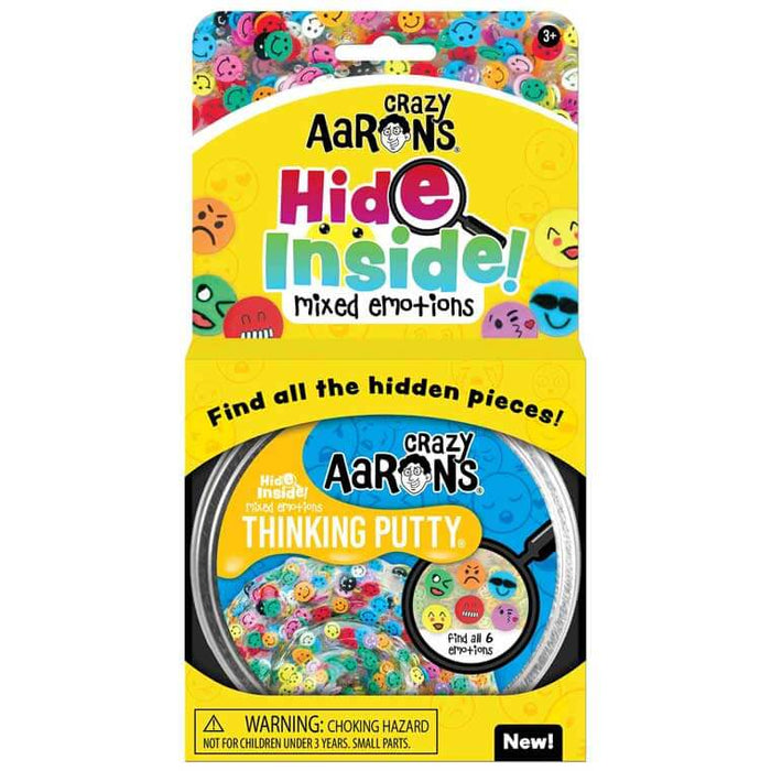 Clear thinking putty with colorful emoji charms inside yellow packaging with a magnifying glass graphic.
