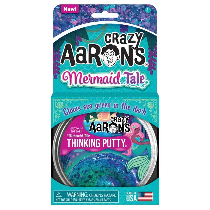 Sparkly blue and purple putty in a tin, inside a teal mermaid-themed box with glow-in-the-dark text.