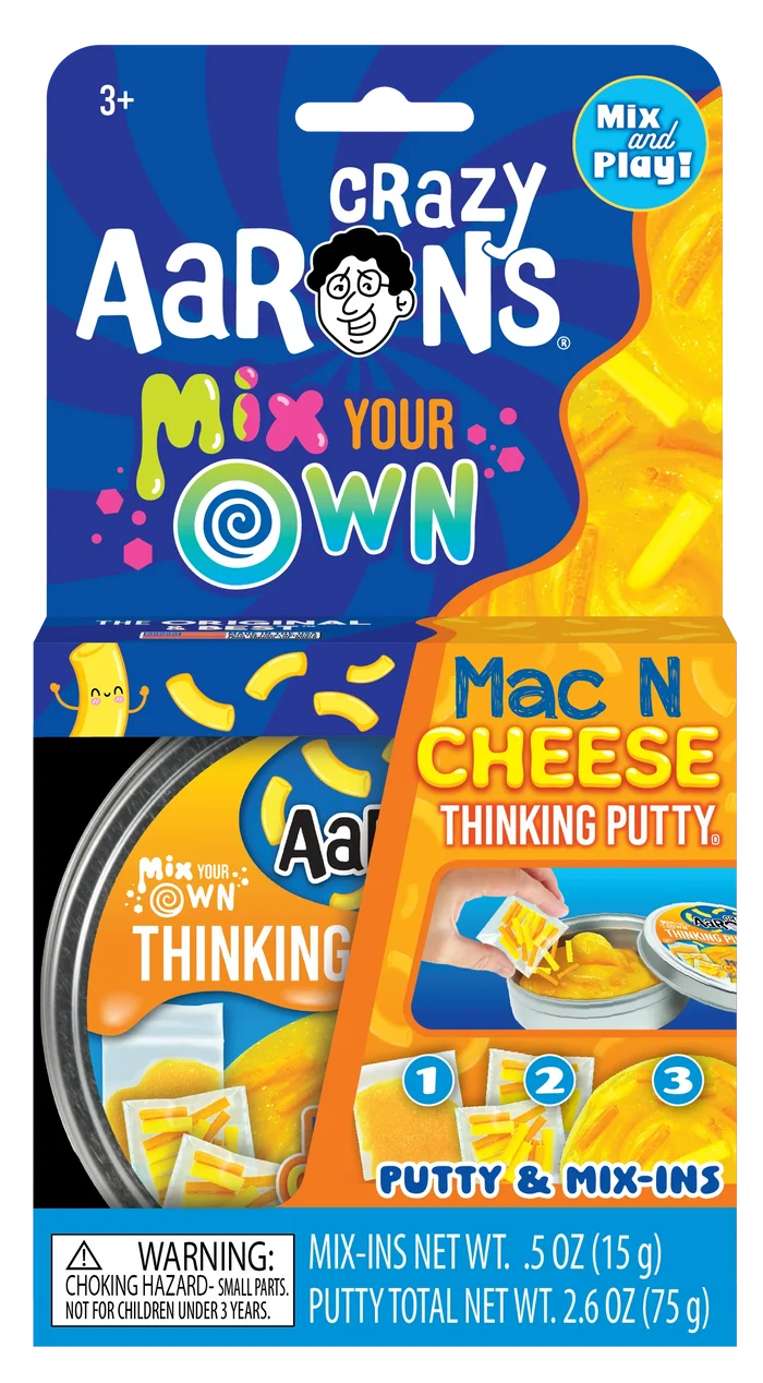 Crazy Aaron's Mac N Cheese putty kit in blue and orange packaging with a tin, mix-ins, and yellow noodle charms.