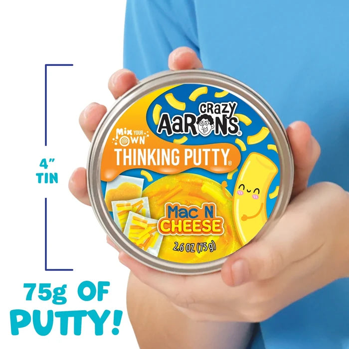 Child holding a 4-inch silver tin of yellow mac and cheese thinking putty with macaroni-shaped mix-ins.