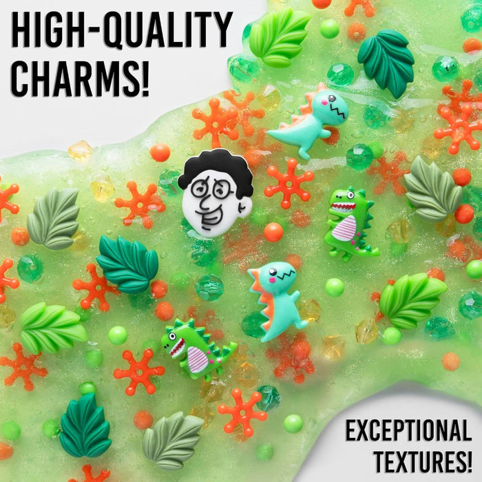 Sparkly green slime filled with dinosaur, leaf, and cartoon face charms, plus orange splats and colorful beads.