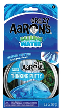 Clear blue putty in a round tin set against blue cardstock packaging with mountain and waterfall illustrations.