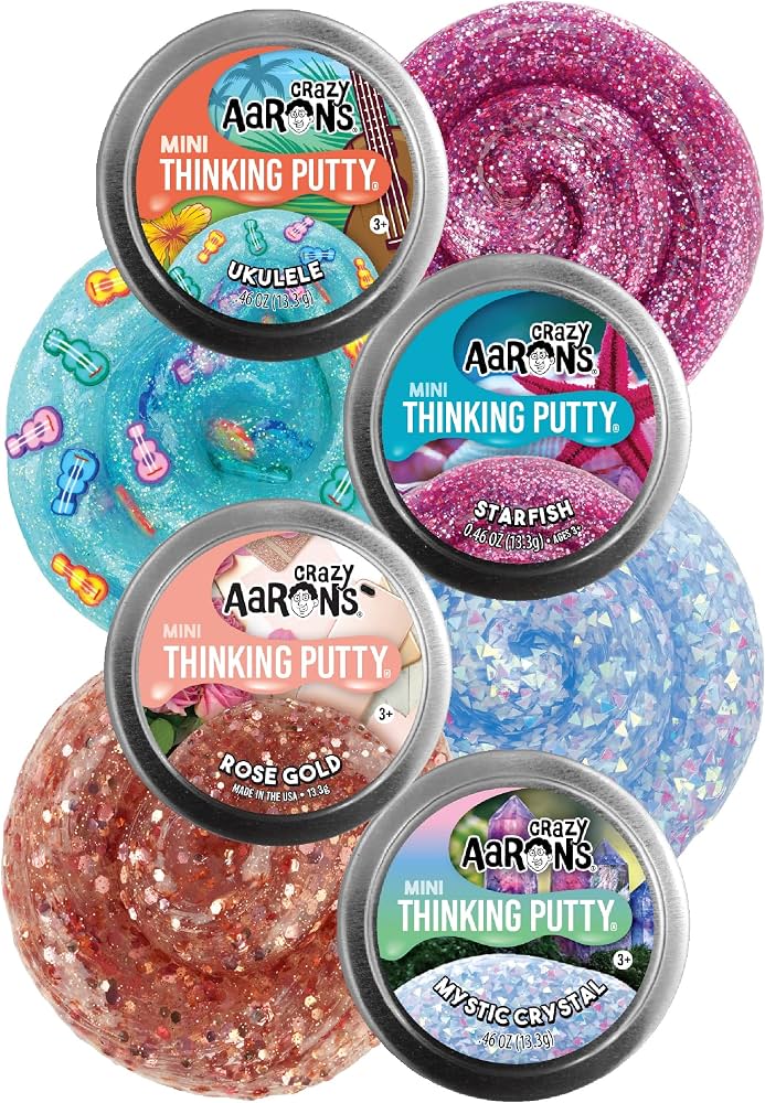Four silver tins with glittery blue with guitar charms, bright pink, rose gold, and iridescent crystal putty samples.