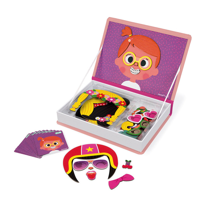 Open pink magnetic book with cartoon face magnets, hair accessories, glasses, and character inspiration cards.