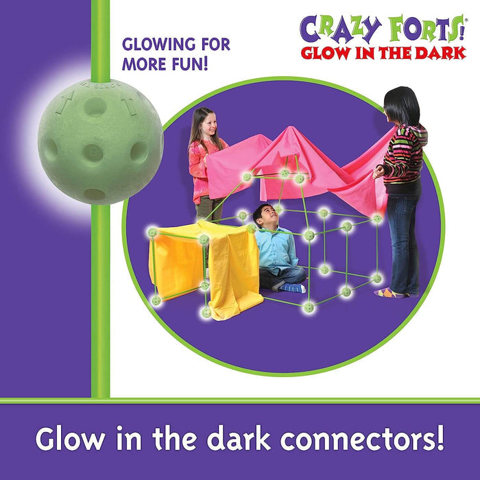 Children building a fort using glowing green ball connectors and poles, covered with pink and yellow fabric sheets.