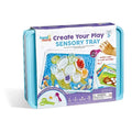 Light blue sensory bin with a white sleeve showing a beach play scene, toy scoop, tongs, and activity cards.