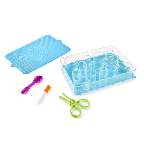Blue sensory kit featuring a textured mat, clear sorting tray, purple scoop, orange dropper, and green tongs.