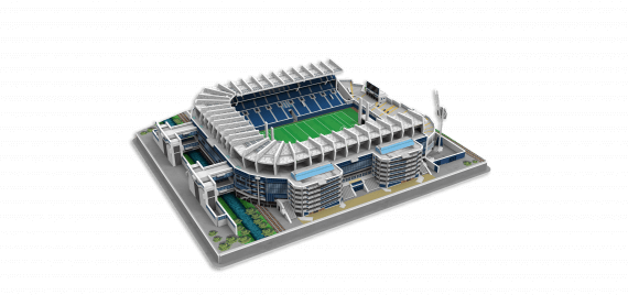 Assembled 3D puzzle model of Croke Park stadium with white roof, blue tiered seating, and green pitch on a grey base.
