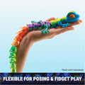 Faceted rainbow-colored articulated gecko toy held in a hand, showing its flexible, segmented crystal-like design.
