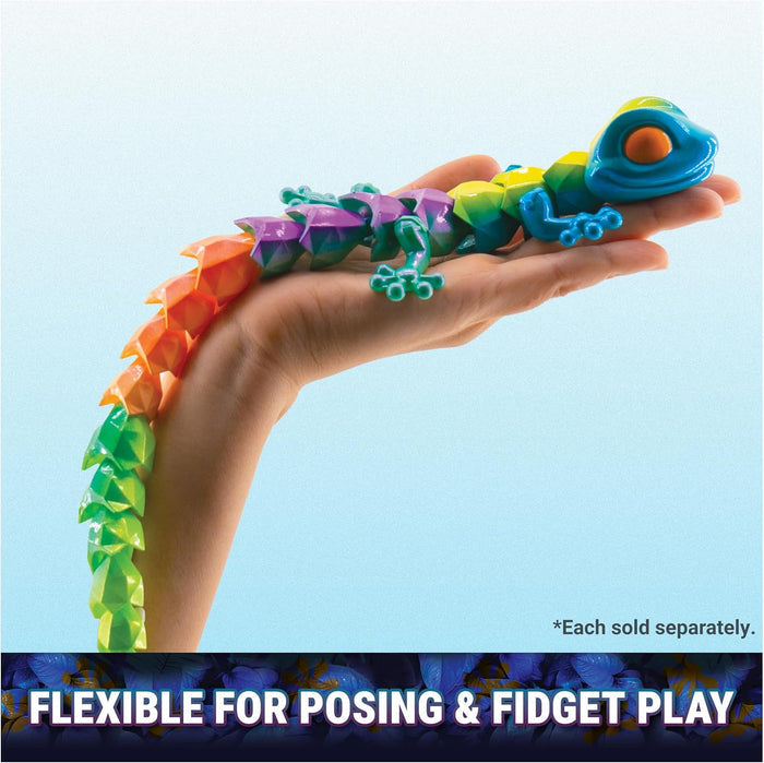 Faceted rainbow-colored articulated gecko toy held in a hand, showing its flexible, segmented crystal-like design.