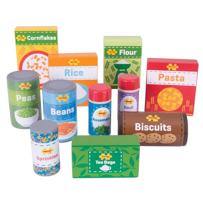 Brightly colored wooden toy grocery boxes, cans, and jars labeled cornflakes, pasta, beans, tea bags, and more.