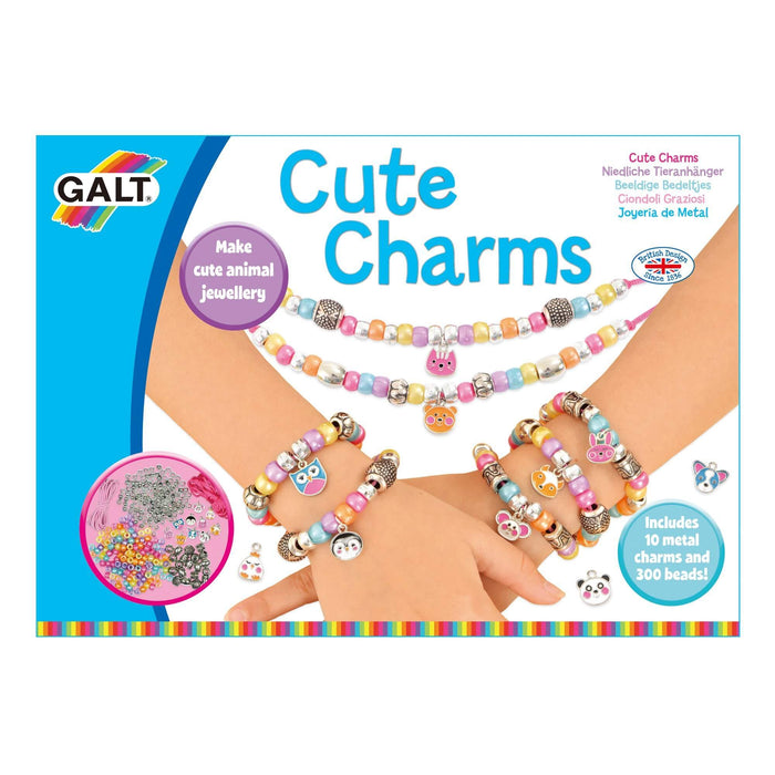 Child wearing colorful beaded bracelets with metal animal charms on Galt Cute Charms craft kit packaging.